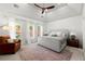 Spacious main bedroom with large windows, tray ceiling, and a cozy sitting area at 2930 Ringle Rd, Brookhaven, GA 30341