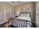 Cozy bedroom with hardwood floors, a wrought iron bed frame, and a side window at 314 Lakeside Trce, Canton, GA 30115