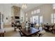 Bright living room featuring a stone fireplace, vaulted ceilings, large windows, and elegant decor at 314 Lakeside Trce, Canton, GA 30115