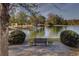 Relaxing view of a pond with a bench and manicured bushes at 314 Lakeside Trce, Canton, GA 30115
