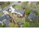 Overhead view of the property featuring a large, well-kept lawn, landscaped gardens, and a wooden deck at 4950 Willow Creek Dr, Woodstock, GA 30188