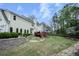 Backyard features a multi-tiered yard, stone edging, and mature trees at 4950 Willow Creek Dr, Woodstock, GA 30188