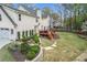 Backyard featuring a wooden deck, lush lawn, and professionally landscaped garden beds at 4950 Willow Creek Dr, Woodstock, GA 30188