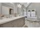 Large primary bath boasts double sinks, tub, and stand alone shower with lots of light at 4950 Willow Creek Dr, Woodstock, GA 30188