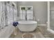 Large primary bath boasts a soaking tub and lots of light at 4950 Willow Creek Dr, Woodstock, GA 30188