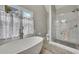 Large primary bath boasts a soaking tub and glass shower at 4950 Willow Creek Dr, Woodstock, GA 30188