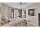 Cozy bedroom with neutral walls, ceiling fan, and a window providing natural light at 4950 Willow Creek Dr, Woodstock, GA 30188