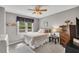 Bright bedroom with a ceiling fan, large window and a dresser at 4950 Willow Creek Dr, Woodstock, GA 30188