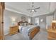 Bright primary bedroom with wood furniture, ceiling fan, and windows for natural light at 4950 Willow Creek Dr, Woodstock, GA 30188