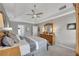 Bright primary bedroom with wood furniture, ceiling fan, and windows for natural light at 4950 Willow Creek Dr, Woodstock, GA 30188
