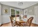 Breakfast nook with a wooden table and four chairs has windows overlooking backyard at 4950 Willow Creek Dr, Woodstock, GA 30188