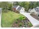 Beautiful two-story home with a well-manicured lawn and a long driveway leading to a two-car garage at 4950 Willow Creek Dr, Woodstock, GA 30188