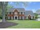 Charming two-story brick home with black shutters and a well-manicured front yard, perfect for curb appeal at 4950 Willow Creek Dr, Woodstock, GA 30188