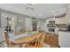 Breakfast nook adjacent to an open kitchen featuring stainless steel appliances and white cabinets at 4950 Willow Creek Dr, Woodstock, GA 30188