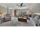 Spacious living room with a large sectional couch, armchair, and a ceiling fan at 4950 Willow Creek Dr, Woodstock, GA 30188