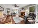 Cozy living room with hardwood floors, fireplace, and a comfortable seating arrangement at 4950 Willow Creek Dr, Woodstock, GA 30188