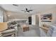 Bright upstairs living room featuring a gray sectional, television, and ceiling fan at 4950 Willow Creek Dr, Woodstock, GA 30188
