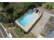 Aerial view of a community pool with marked lanes, surrounding greenery, parking, and a small gazebo at 4950 Willow Creek Dr, Woodstock, GA 30188