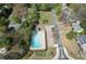 Aerial shot of the pool highlighting well-defined lanes, gazebo, parking, and landscaping in a community setting at 4950 Willow Creek Dr, Woodstock, GA 30188