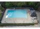 Overhead view of a community pool with marked lanes, lounge seating, and manicured shrubs at 4950 Willow Creek Dr, Woodstock, GA 30188