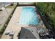 Aerial view of pool showing marked swimming lanes, with lounge seating and mature landscaping at 4950 Willow Creek Dr, Woodstock, GA 30188