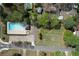 Aerial view of community pool with lanes, gazebo, parking, and adjacent empty grassy lot at 4950 Willow Creek Dr, Woodstock, GA 30188