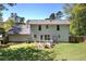This backyard features a large, grassy area, a patio, a fenced perimeter and mature trees at 105 Whisper Way, Dacula, GA 30019