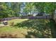 This backyard features a large, grassy area, a patio, a fenced perimeter and mature trees at 105 Whisper Way, Dacula, GA 30019