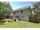 This backyard features a large, grassy area, a patio, a fenced perimeter and mature trees at 105 Whisper Way, Dacula, GA 30019