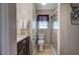 This bathroom features neutral walls, tile shower, wood-style flooring and a decorative wall hanging at 105 Whisper Way, Dacula, GA 30019
