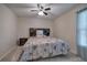 This bedroom features a ceiling fan, carpet flooring, and a decorative upholstered headboard at 105 Whisper Way, Dacula, GA 30019