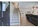 Front entryway with view of carpeted stairs leading up and an open-concept living room space at 105 Whisper Way, Dacula, GA 30019