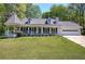 Charming home with a manicured lawn, covered porch, and turret-style gazebo at 105 Whisper Way, Dacula, GA 30019