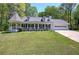 Charming home with a manicured lawn, covered porch, and turret-style gazebo at 105 Whisper Way, Dacula, GA 30019
