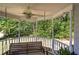 Charming gazebo with a ceiling fan and swing facing the trees in the backyard at 105 Whisper Way, Dacula, GA 30019