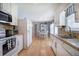 Kitchen with butcher block countertops, stainless sink, laminate wood flooring, and white cabinets at 105 Whisper Way, Dacula, GA 30019