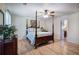 Main bedroom featuring a four poster bed, hardwood floors, and a ceiling fan at 105 Whisper Way, Dacula, GA 30019