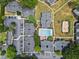 Aerial view of an apartment community featuring a swimming pool, volleyball court, and ample parking at 1150 Collier Nw Rd # A7, Atlanta, GA 30318