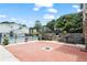 Community outdoor pool surrounded by brick patio, stone retaining wall, and well-maintained landscaping at 1150 Collier Nw Rd # A7, Atlanta, GA 30318