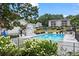 Community pool with chairs, lounge chairs, landscaping, and nearby apartment buildings at 1150 Collier Nw Rd # A7, Atlanta, GA 30318