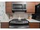 Well-lit kitchen featuring stainless steel appliances, sleek wood cabinets, and modern fixtures for cooking at 1150 Collier Nw Rd # A7, Atlanta, GA 30318