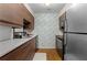 Modern kitchen with stainless steel appliances, ample counter space, and sleek wood cabinetry for easy organization at 1150 Collier Nw Rd # A7, Atlanta, GA 30318