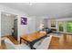 Open floor plan with hardwood floors, dining area, and access to a balcony overlooking greenery at 1150 Collier Nw Rd # A7, Atlanta, GA 30318
