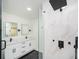 Modern bathroom showcasing dual vanity, shower with glass surround, and marble tile walls at 2190 Highview Rd, Atlanta, GA 30311