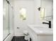 Bathroom featuring tub with glass door and quartz vanity with modern fixtures at 2190 Highview Rd, Atlanta, GA 30311