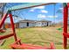Backyard featuring a swing set, green lawn, and view of the house's exterior at 2984 Bayard St, East Point, GA 30344