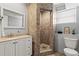 Modern bathroom features a walk-in shower, large mirror, sleek vanity, and tiled floors at 2984 Bayard St, East Point, GA 30344