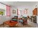 Cozy bedroom featuring seating area, comfortable bed, ceiling fan, and natural light from a window at 2984 Bayard St, East Point, GA 30344