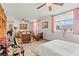 This well-lit bedroom boasts a sofa, bed, modern ceiling fan, and an array of stylish art at 2984 Bayard St, East Point, GA 30344