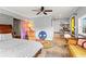 Spacious bedroom with a ceiling fan, desk, bed, and stylish decor, ideal for a comfortable living space at 2984 Bayard St, East Point, GA 30344